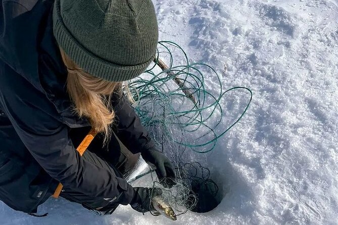 Arctic Fishing & Open Fire Cooking - Drilling through thick ice on Lake Inari