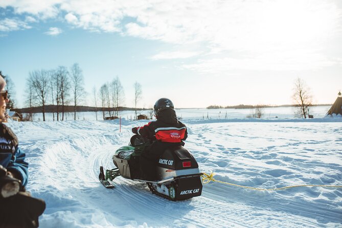 Family Snowmobiling in Rovaniemi, Apukka Resort - A family snowmobile ride through Apukka’s snowy forest