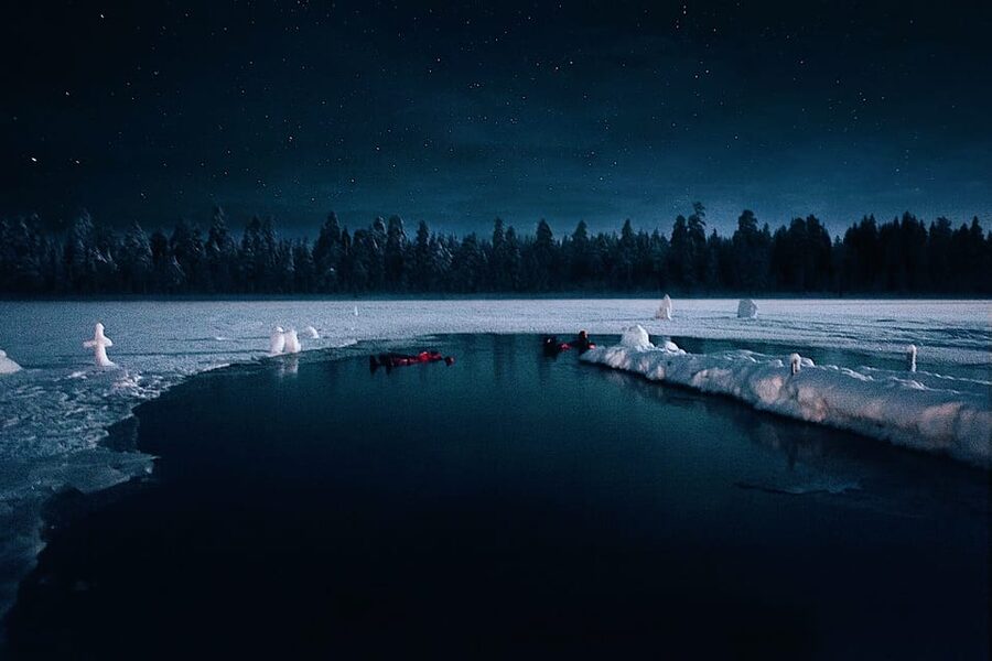 From Rovaniemi: Ice Floating under Aurora Borealis - Getting into the water in a rescue suit