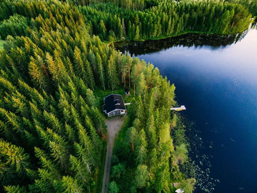 From Rovaniemi: Midnight Sun Forest Lake Float - Floating under the golden Arctic light