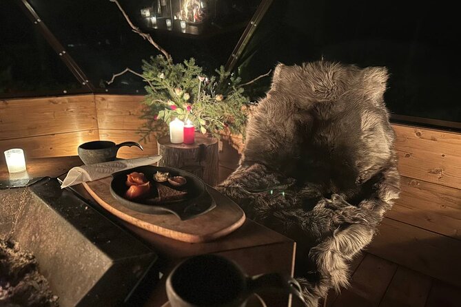 Glass Igloo Campfire Dinner under Northern Lights - The frozen lake adds a playful second act