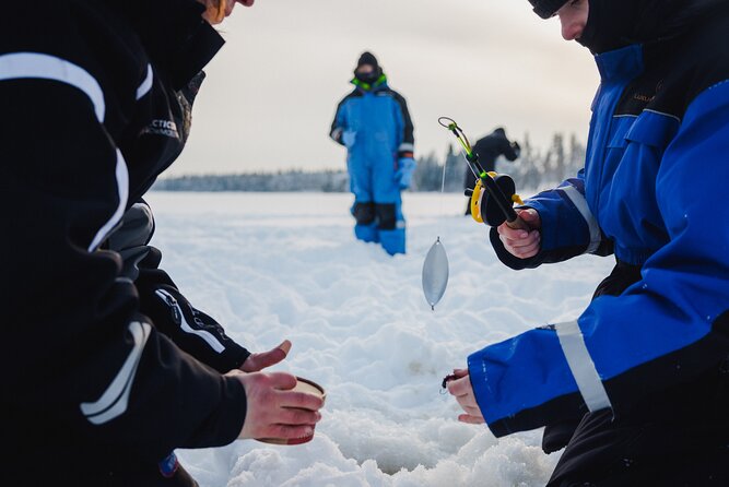 Ice Fishing and Snowmobile Safari Combo in Lapland - Sausages beside a wilderness fire