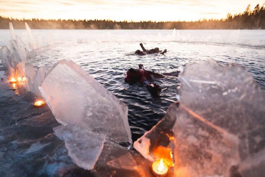 Rovaniemi: Arctic Ice Floating and Northern Lights Tour - Entering the snow-covered lake