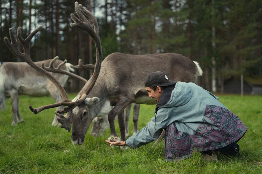 Rovaniemi: Reindeer Farm Visit with Photographer - Warming up by the fire